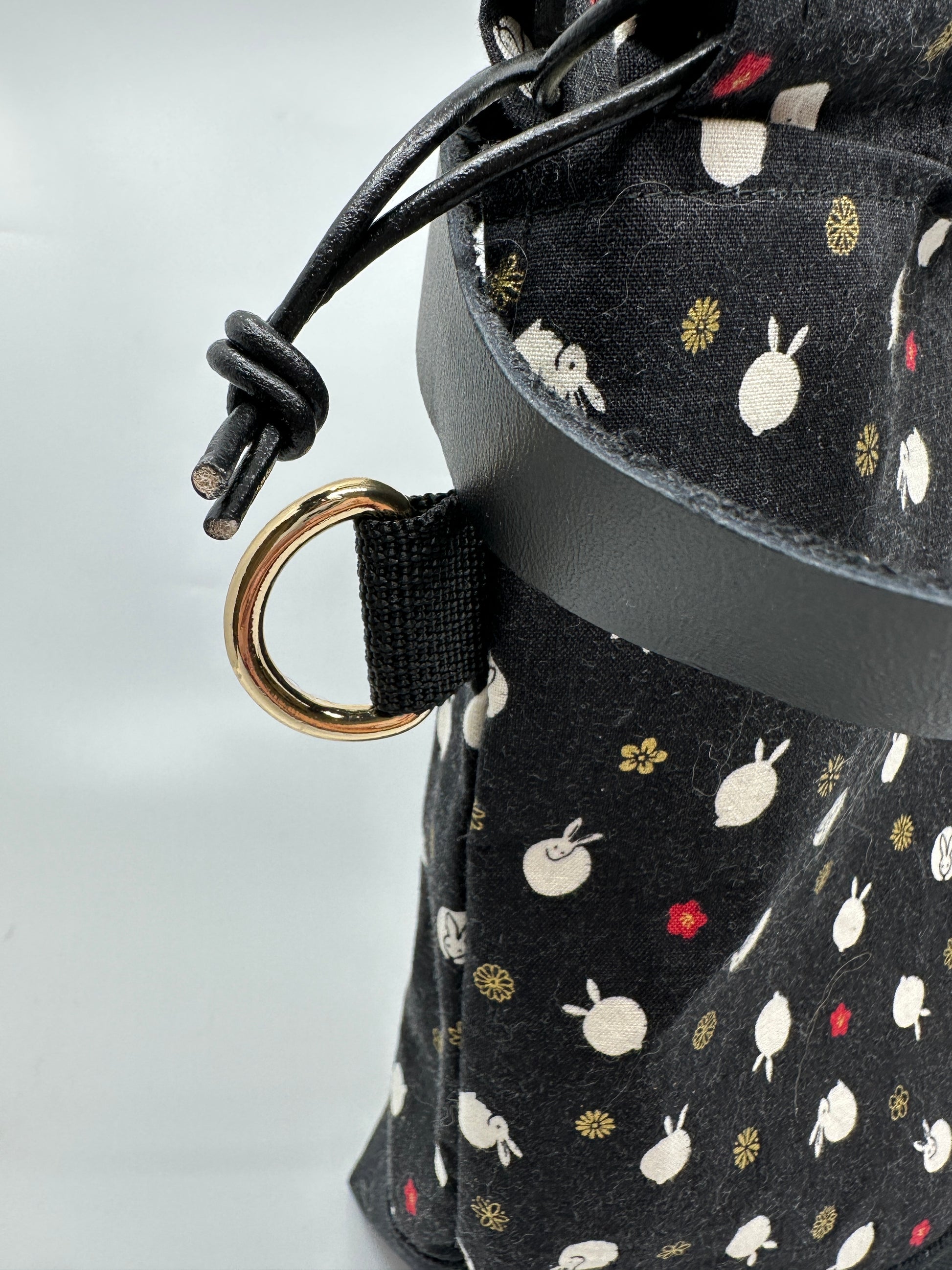 Detail shot of the gold d ring on the polka dot bunnies bag.